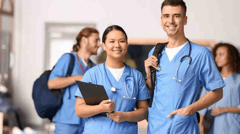 A group of medical residents in scrubs.